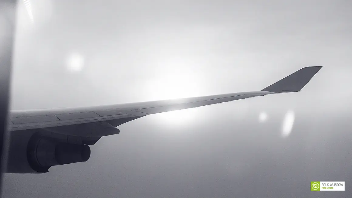 Morning sun above the clouds seen from a plane window